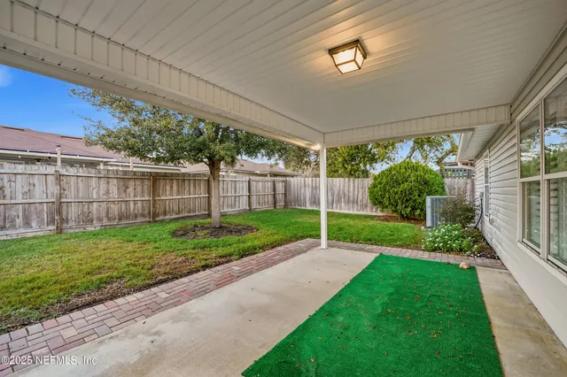 a view of a backyard with plants and a garden