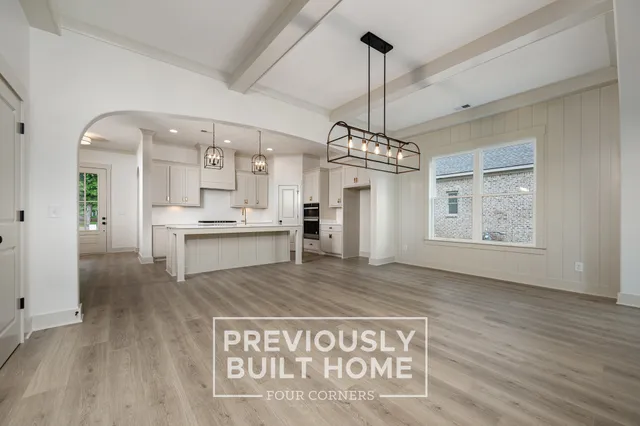 a view of a kitchen center island and stainless steel appliances