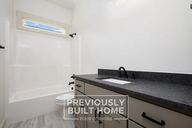 a bath room with a table and a chair