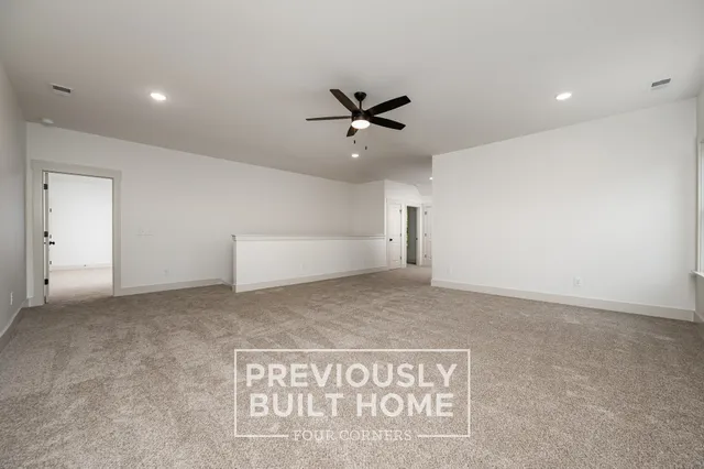 a view of a hallway with wooden floor and closet
