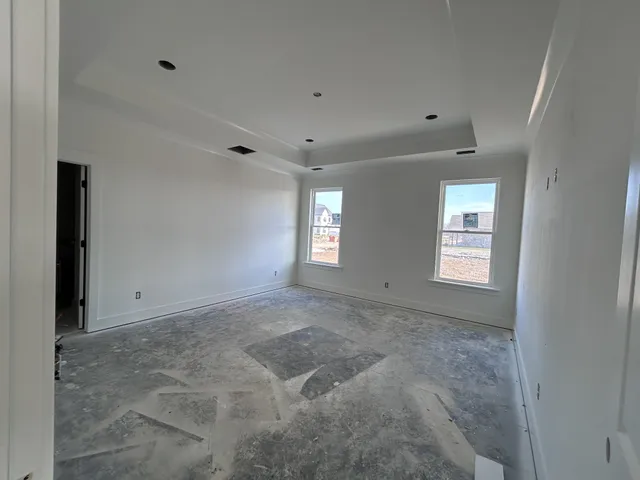 a view of an empty room with windows