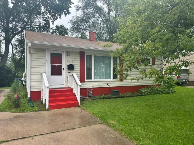a front view of house with yard and swimming pool