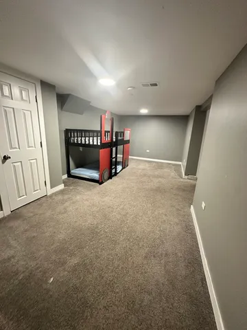 an empty room with furniture and a window