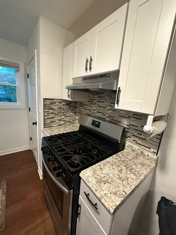 a stove top oven sitting inside of a kitchen