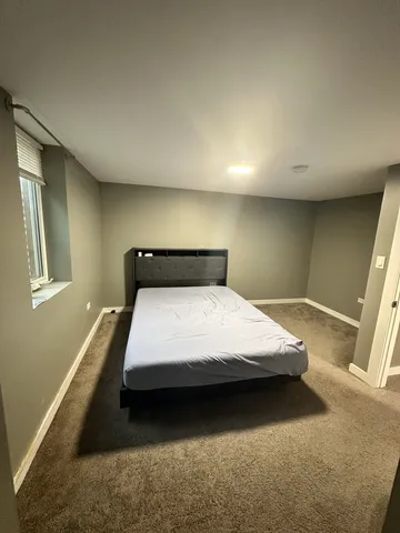 a bedroom with bed and window