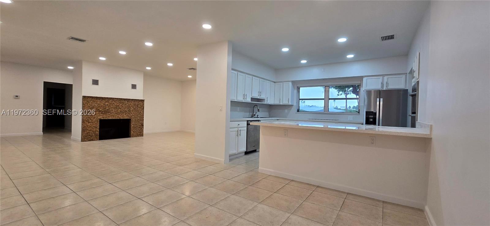 6500 Southwest 82nd Avenue Miami, FL 33143 - Photo 12 of 54 a open kitchen with white cabinets and stainless steel appliances