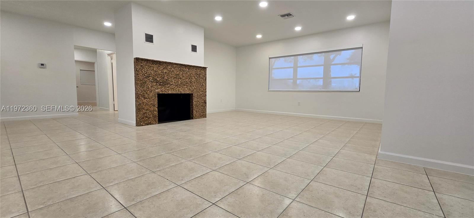 6500 Southwest 82nd Avenue Miami, FL 33143 - Photo 13 of 54 an empty room with windows and fireplace