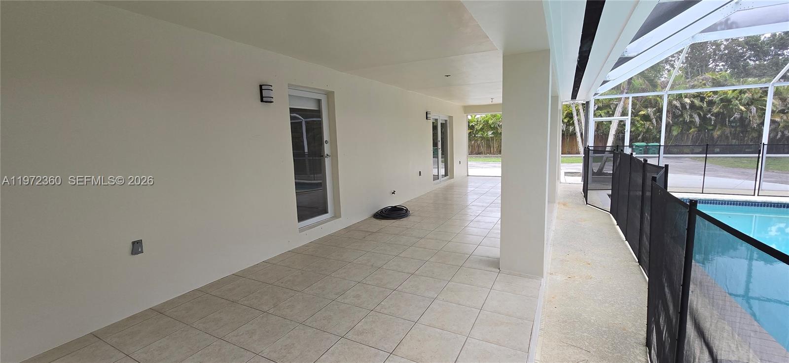 6500 Southwest 82nd Avenue Miami, FL 33143 - Photo 21 of 54 a hallway with sliding door and wooden floor