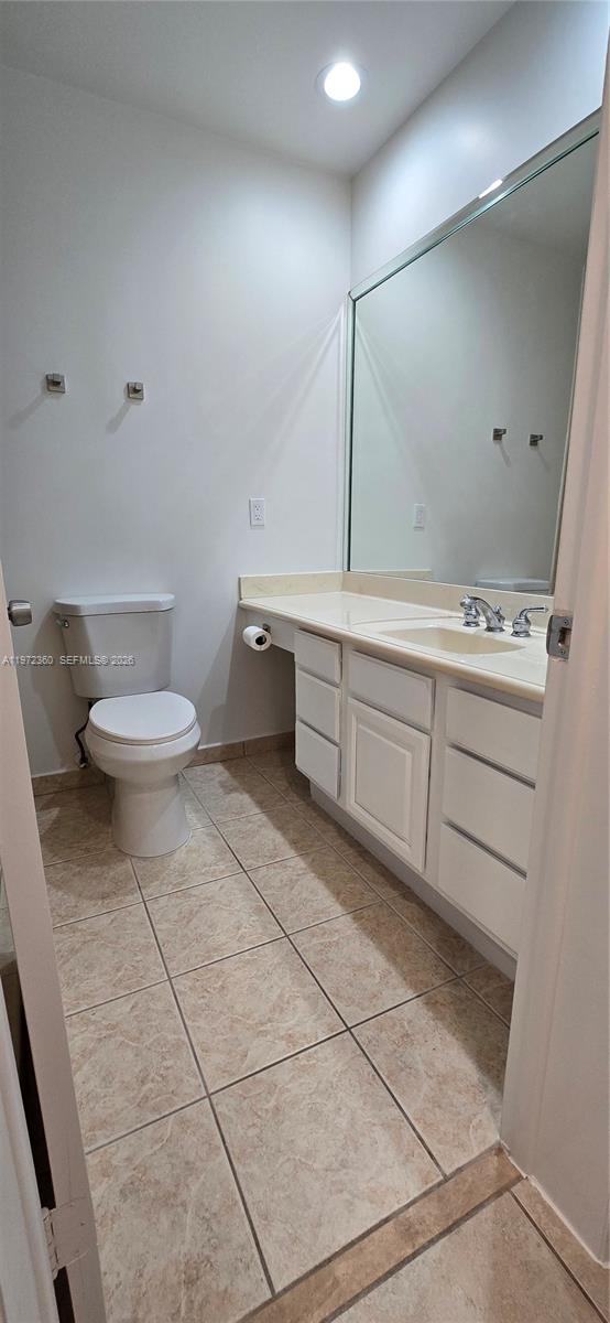 6500 Southwest 82nd Avenue Miami, FL 33143 - Photo 34 of 54 a bathroom with a toilet sink and mirror