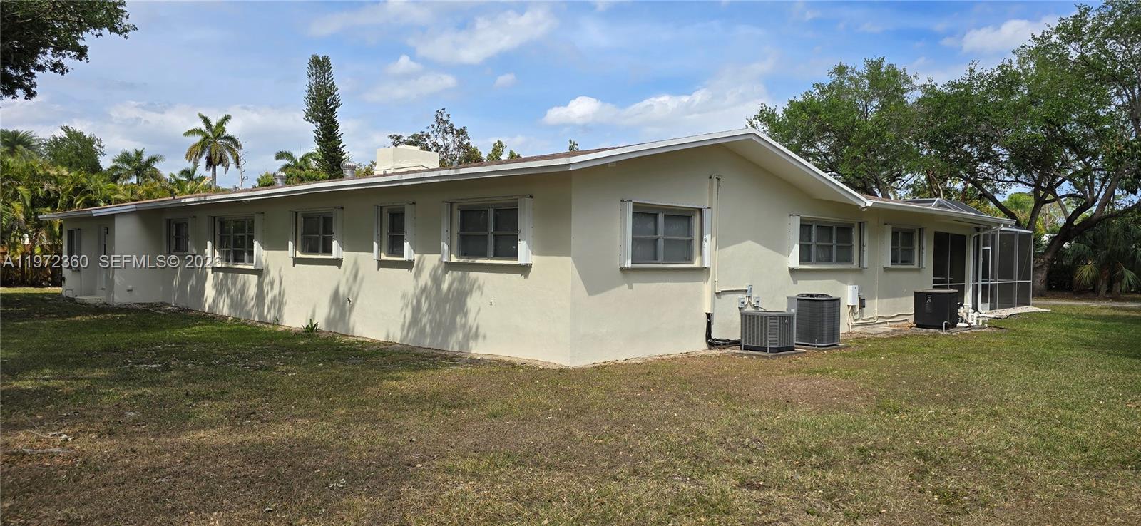 6500 Southwest 82nd Avenue Miami, FL 33143 - Photo 50 of 54 a front view of house with yard and trees in the background