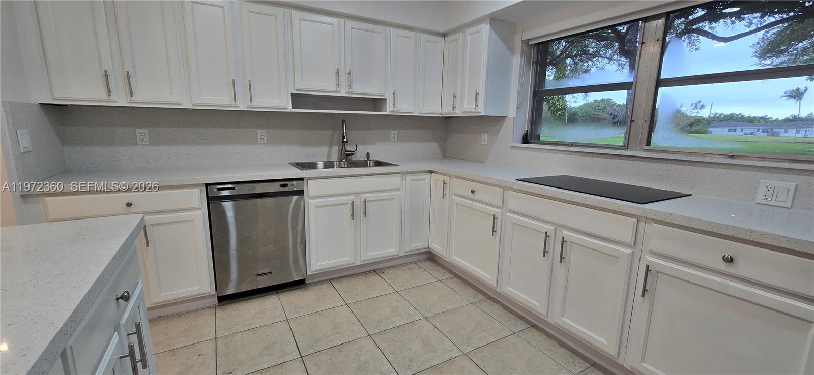6500 Southwest 82nd Avenue Miami, FL 33143 - Photo 6 of 54 a kitchen with white cabinets and white appliances