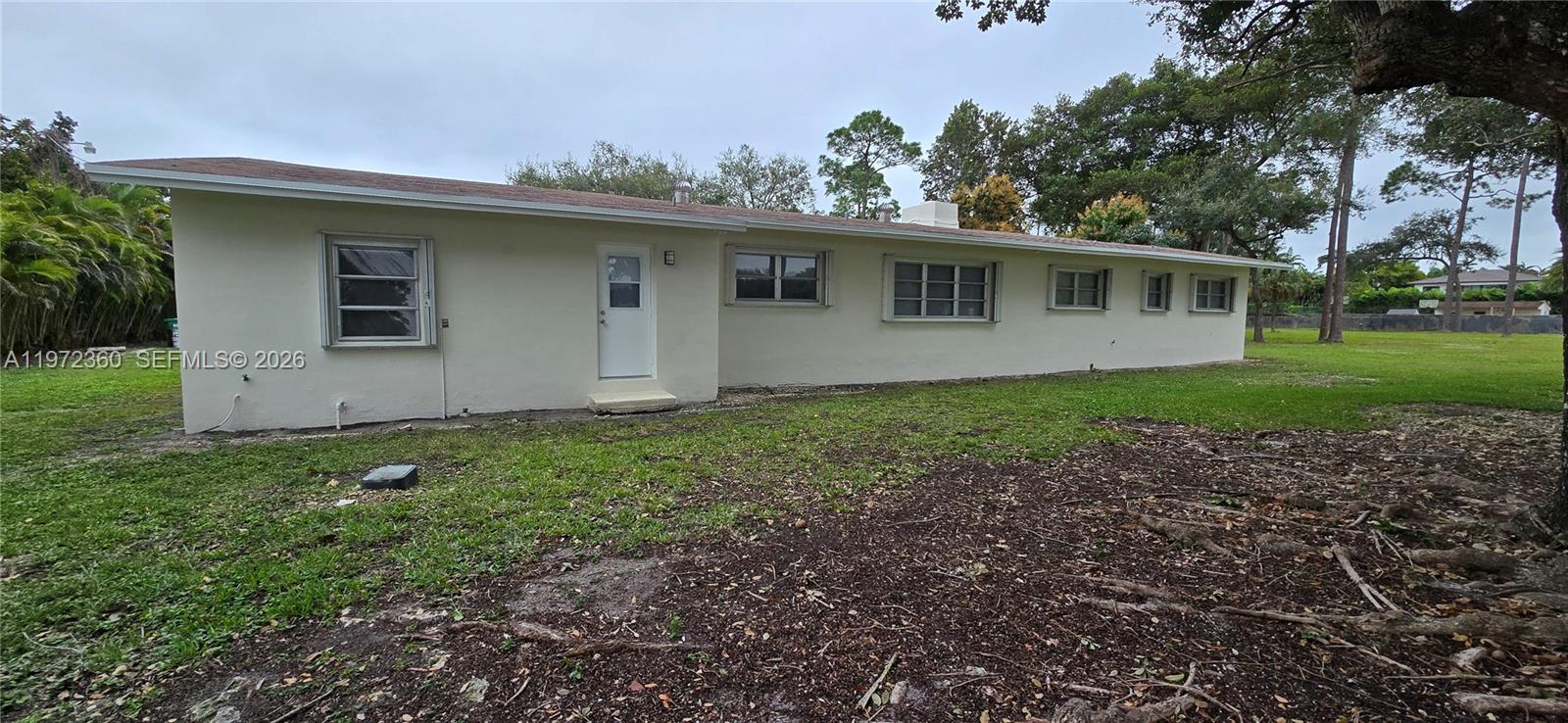 6500 Southwest 82nd Avenue Miami, FL 33143 - Photo 7 of 54 a view of a house with a yard