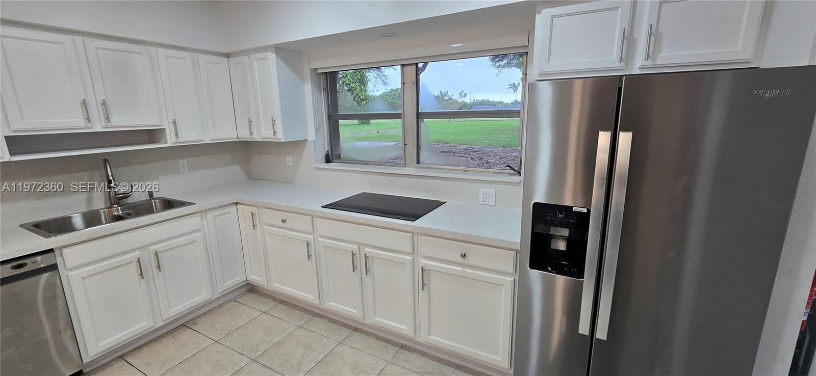 6500 Southwest 82nd Avenue Miami, FL 33143 - Photo 9 of 54 a kitchen with white cabinets and refrigerator