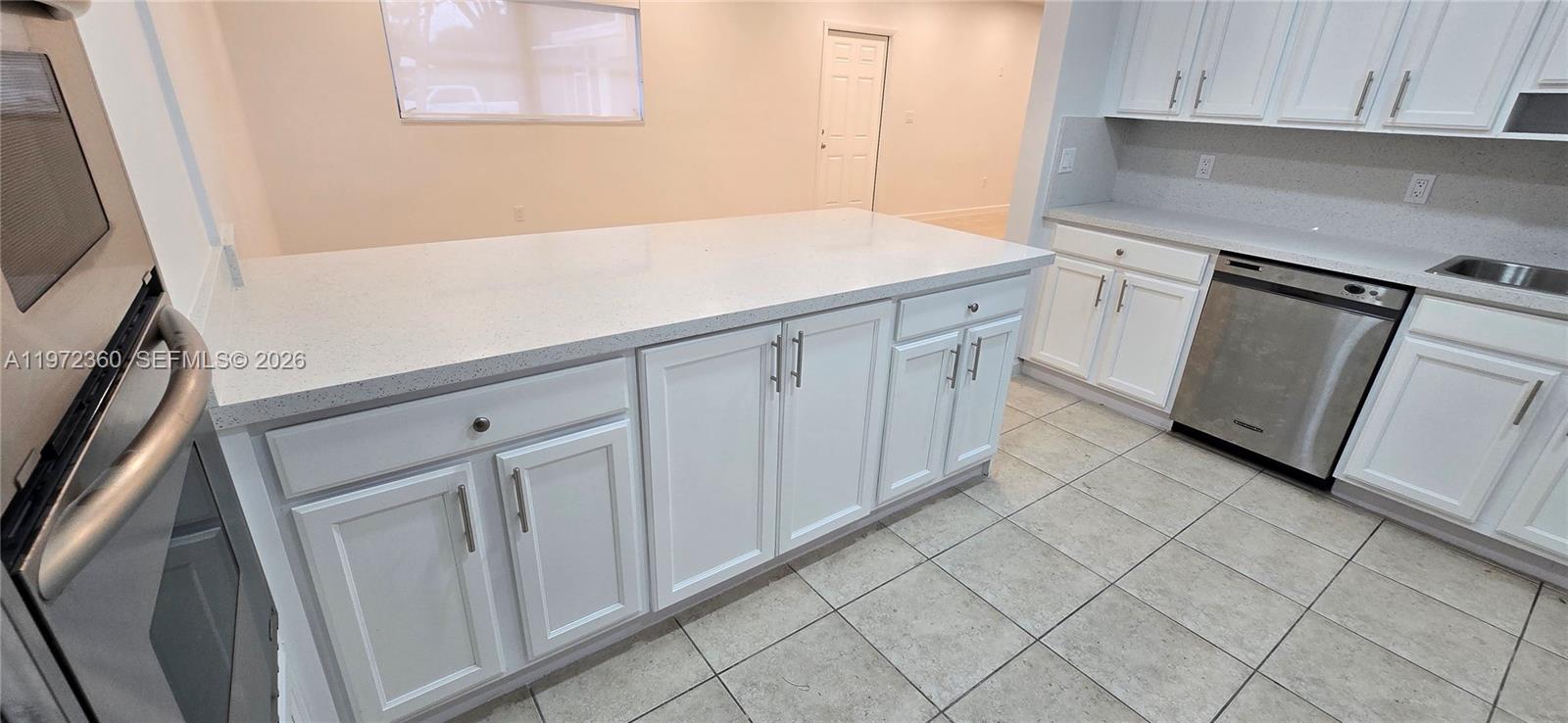 6500 Southwest 82nd Avenue Miami, FL 33143 - Photo 10 of 54 a kitchen with white cabinets
