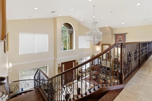 a living room with furniture large window and wooden floor