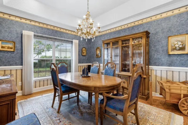 a open dining room with stainless steel appliances furniture a window and kitchen view