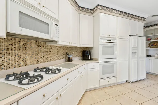 a living room with furniture and large windows