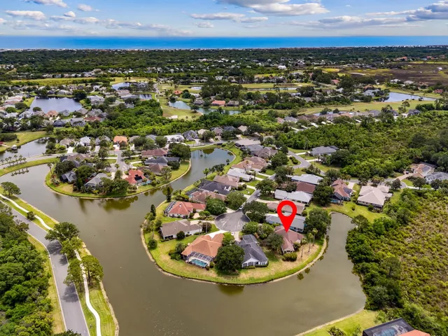 a front view of a house with yard and green space