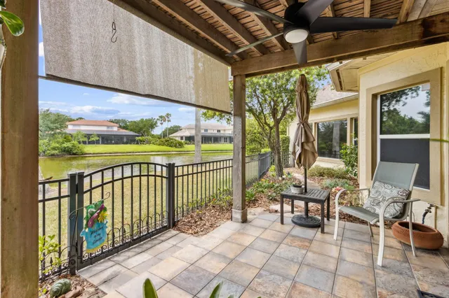 a yellow house sitting next to a yard