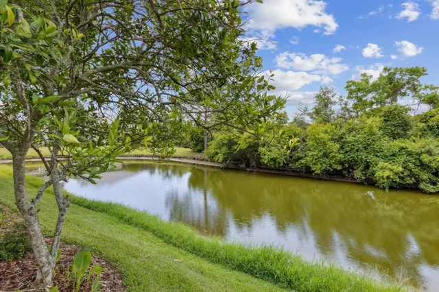 a spacious bedroom with a large bed and a flat screen tv