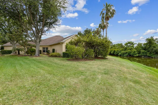 a spacious bedroom with a large bed and a chandelier