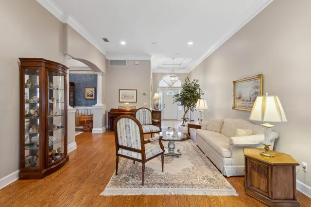 a view of a dining room with furniture a chandelier and wooden floor