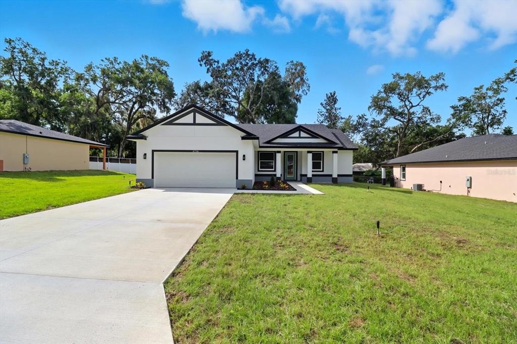 a front view of a house with a yard and garage