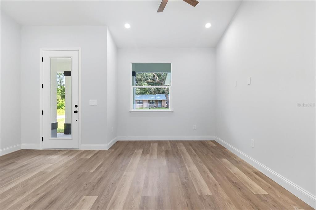 6716 East Crimson Lane Inverness, FL 34452 - Photo 11 of 44 wooden floor in an empty room with a window