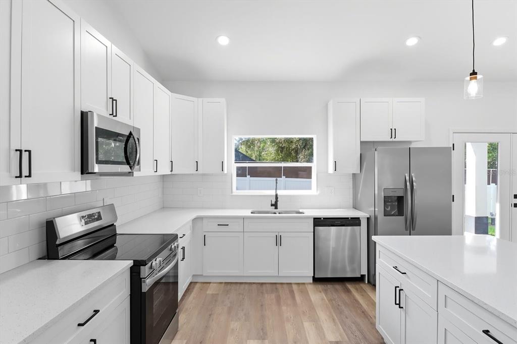 6716 East Crimson Lane Inverness, FL 34452 - Photo 15 of 44 a kitchen with a sink stove top oven and refrigerator