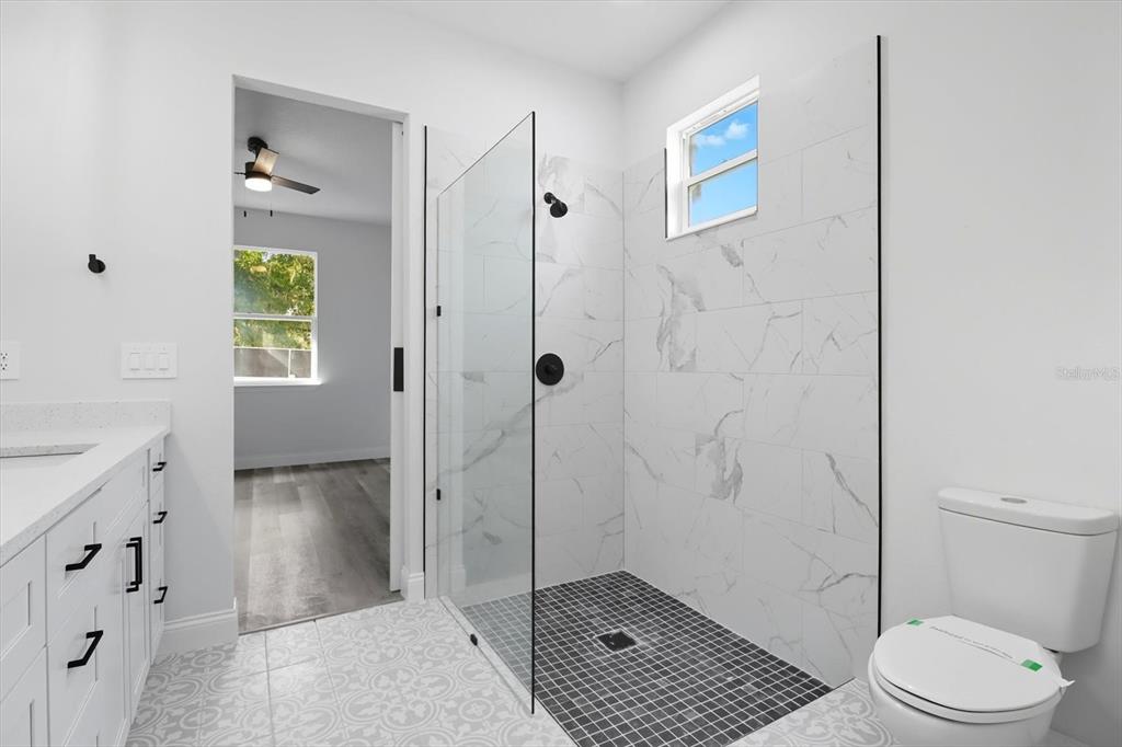 6716 East Crimson Lane Inverness, FL 34452 - Photo 24 of 44 a bathroom with a granite countertop sink a toilet and shower