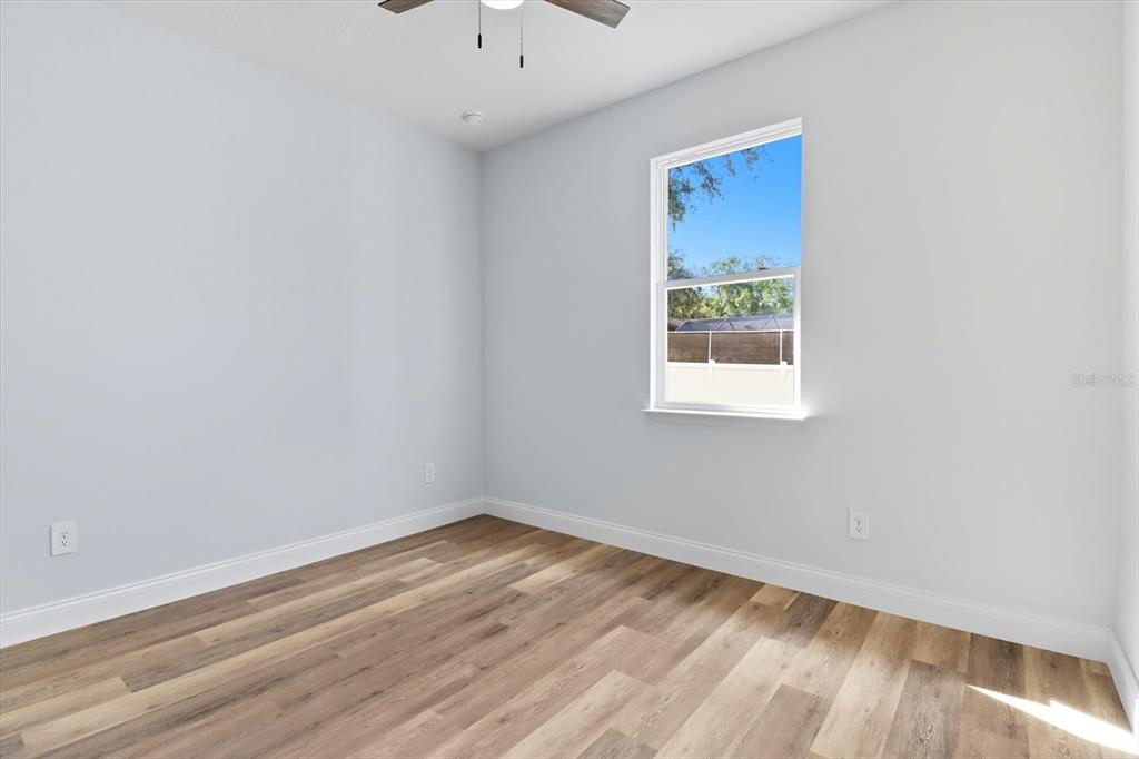 6716 East Crimson Lane Inverness, FL 34452 - Photo 28 of 44 a view of an empty room with wooden floor and a window