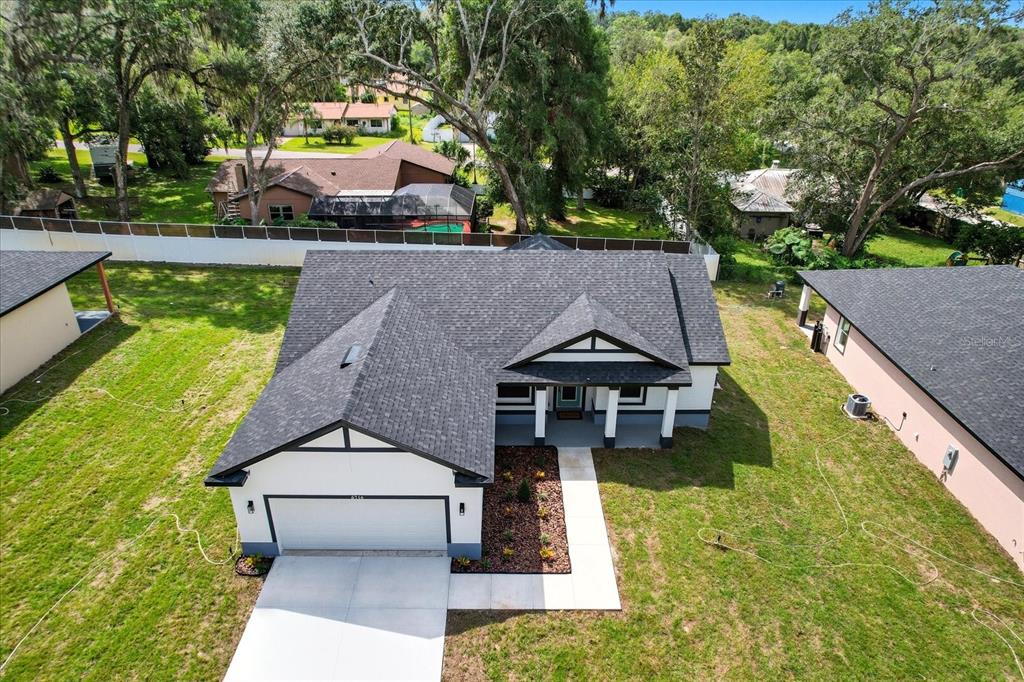 6716 East Crimson Lane Inverness, FL 34452 - Photo 38 of 44 a aerial view of a house with swimming pool next to a yard