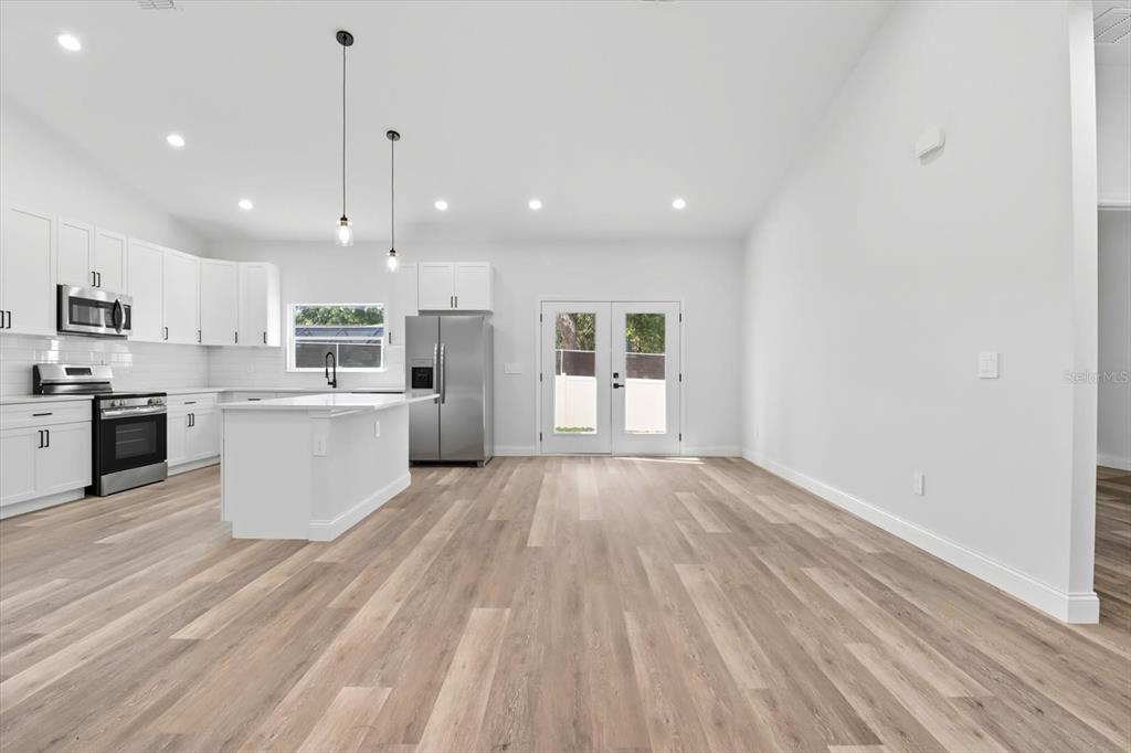 6716 East Crimson Lane Inverness, FL 34452 - Photo 10 of 44 a large kitchen with stainless steel appliances granite countertop a large center island attached withe living room
