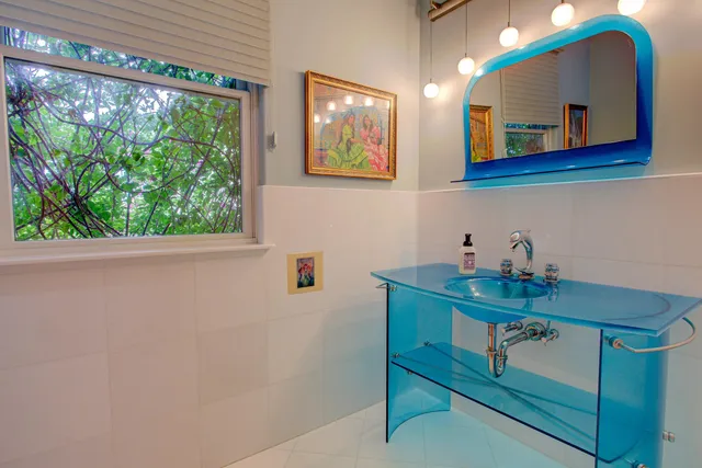 a bathroom with a toilet a sink and a window