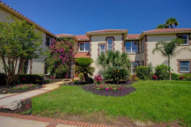 a view of a house with a yard and sitting area