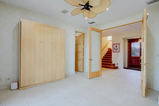 an aerial view of a house with a yard potted plants and large tree
