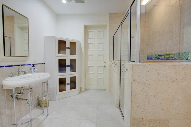 an aerial view of residential houses with outdoor space and a lake view