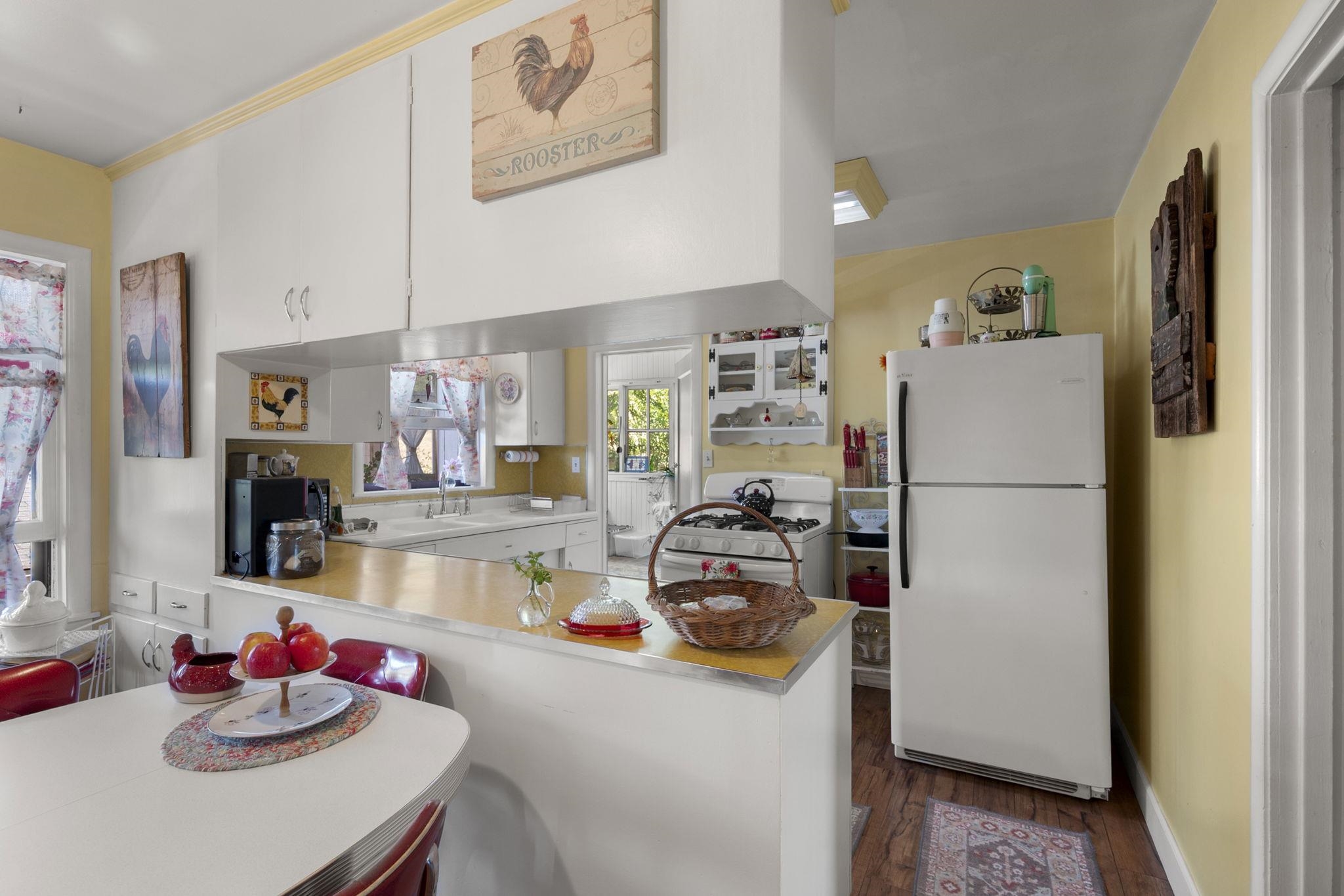 213 Main Street San Andreas, CA 95249 - Photo 19 of 53 a kitchen with a refrigerator a stove and a dining table