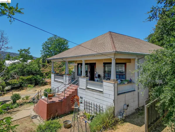 a view of a house with backyard porch and sitting area