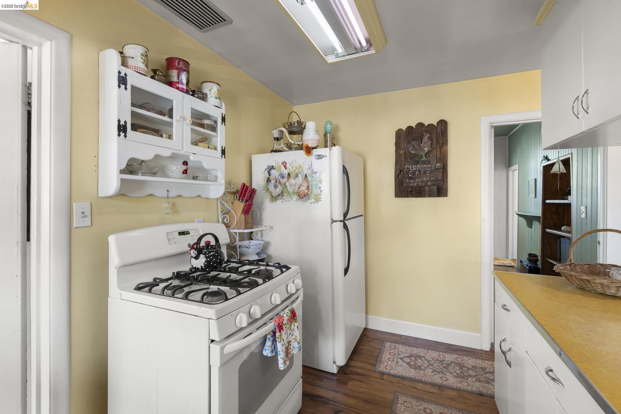 213 Main Street San Andreas, CA 95249 - Photo 22 of 55 a kitchen with a refrigerator and a stove top oven