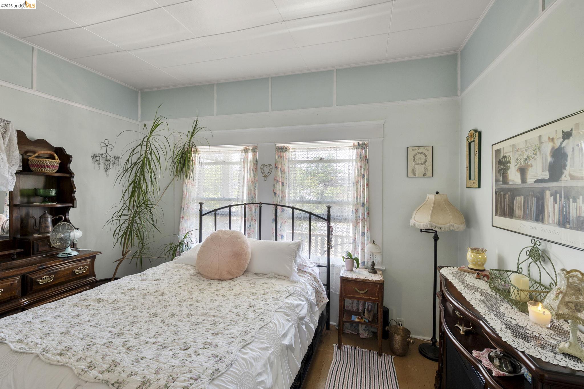 213 Main Street San Andreas, CA 95249 - Photo 25 of 55 a bedroom with a bed and a potted plant on the dresser