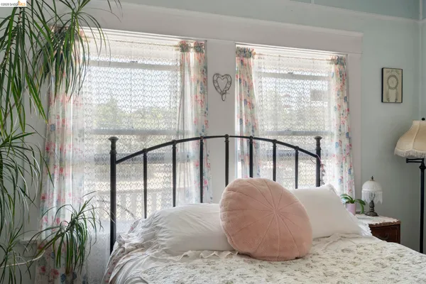 a large bedroom with a large window and a bed