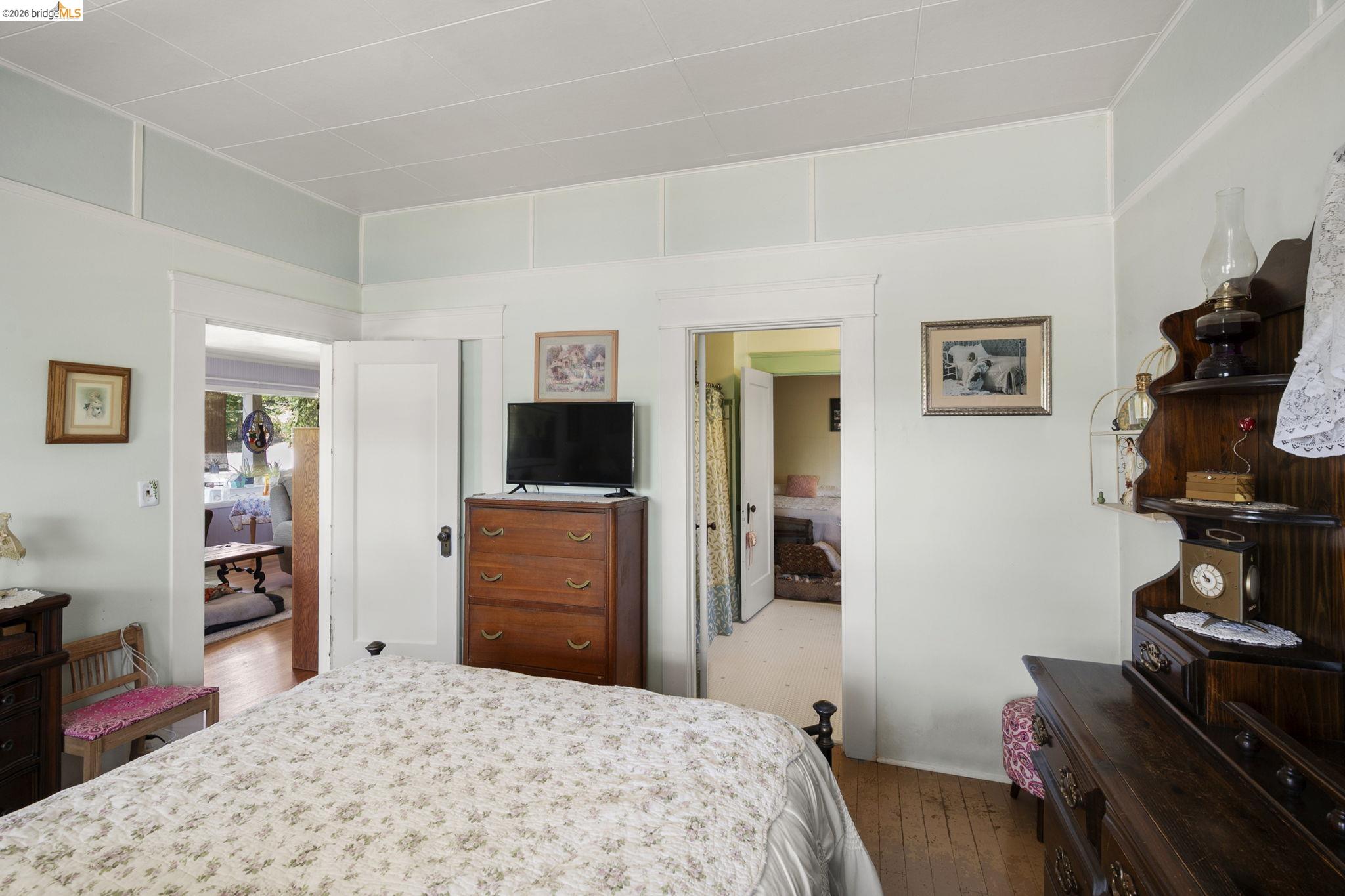 213 Main Street San Andreas, CA 95249 - Photo 28 of 55 a bedroom with a bed and a flat screen tv