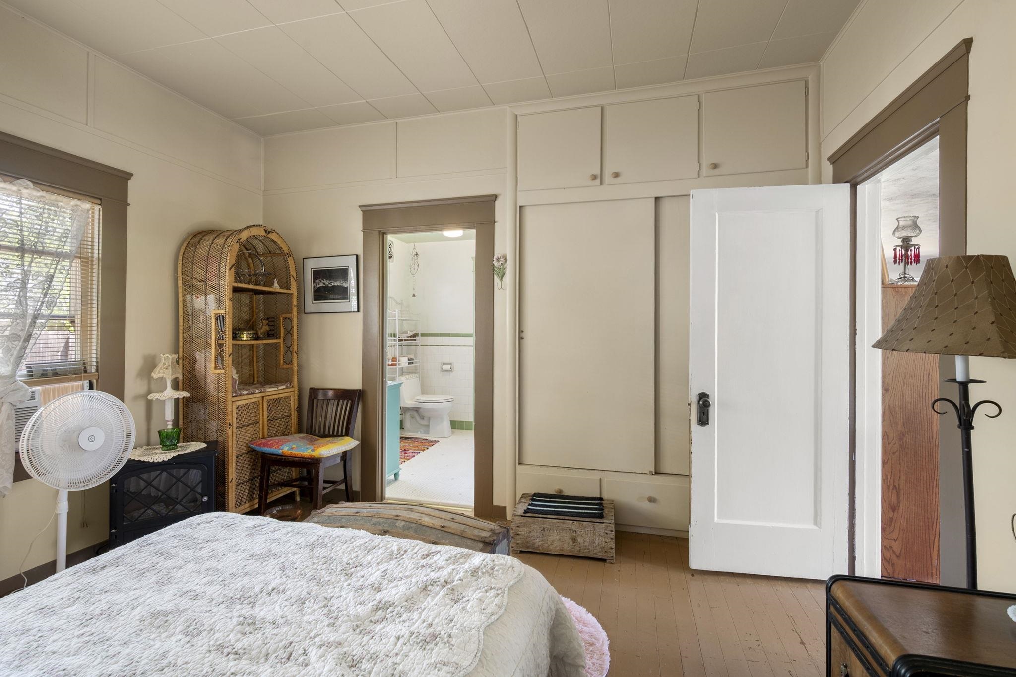 213 Main Street San Andreas, CA 95249 - Photo 33 of 53 a spacious bedroom with a bed a table and large mirror in it