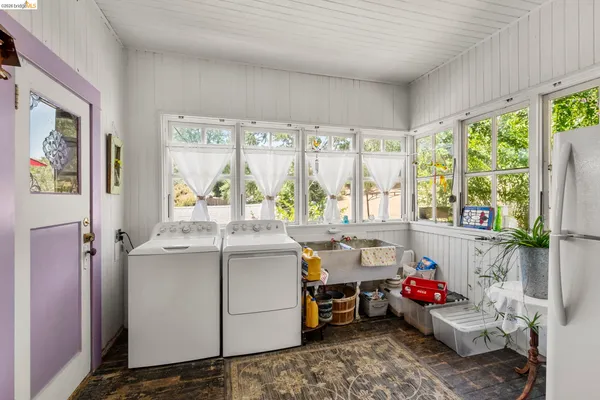 a white refrigerator freezer and a stove sitting inside of a kitchen