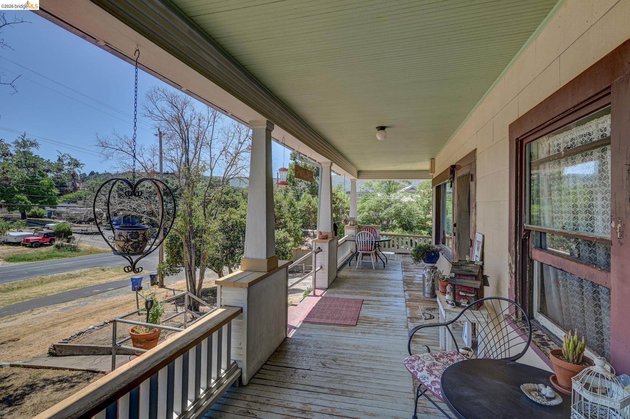 213 Main Street San Andreas, CA 95249 - Photo 42 of 55 a view of a balcony with chairs and wooden floor