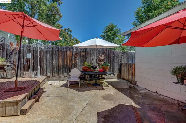 a view of a chair and tables in the patio