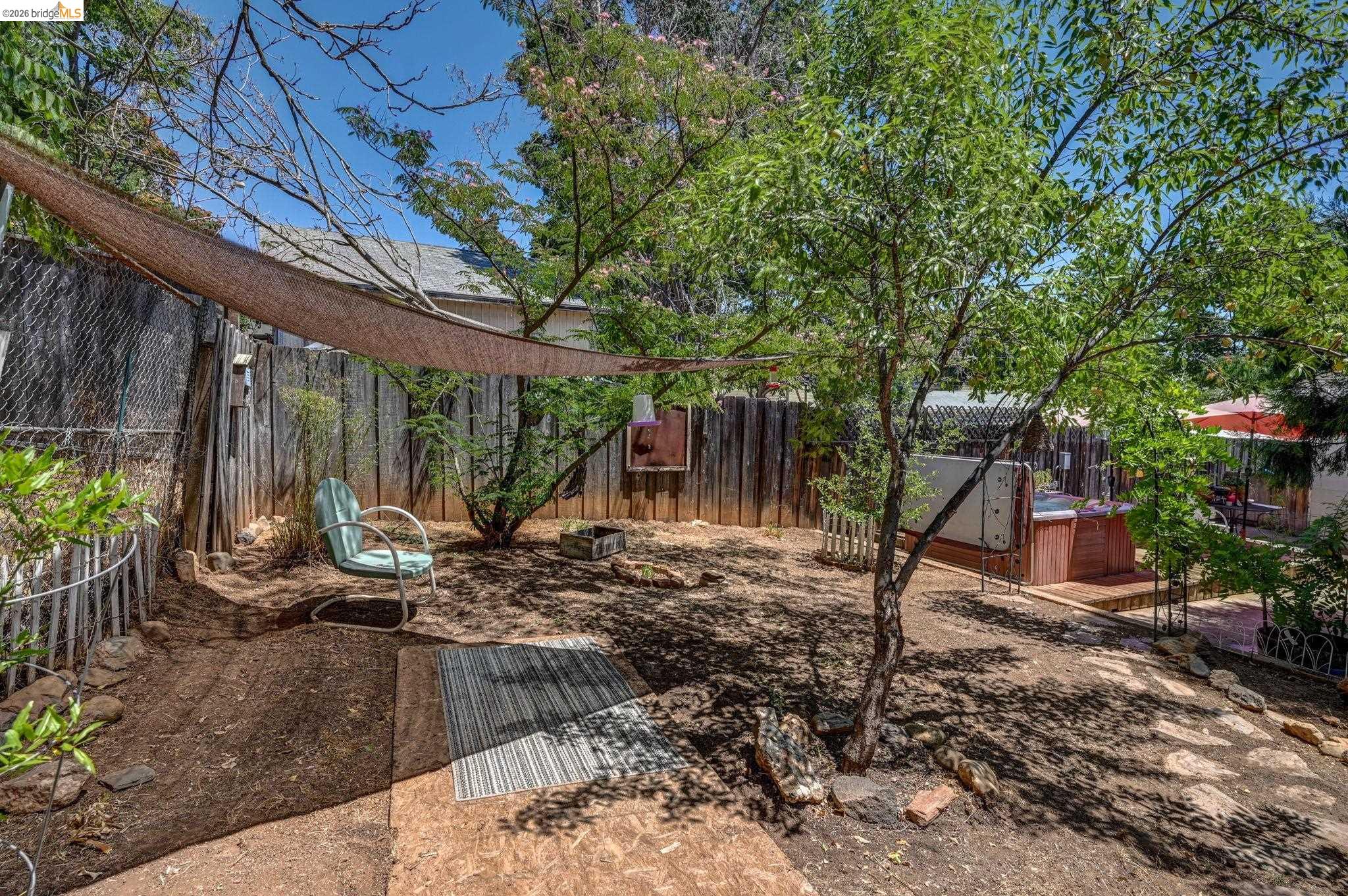 213 Main Street San Andreas, CA 95249 - Photo 51 of 55 a view of a backyard with table and chairs potted plants and large tree