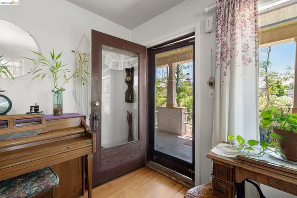 a room with painting and a potted plant