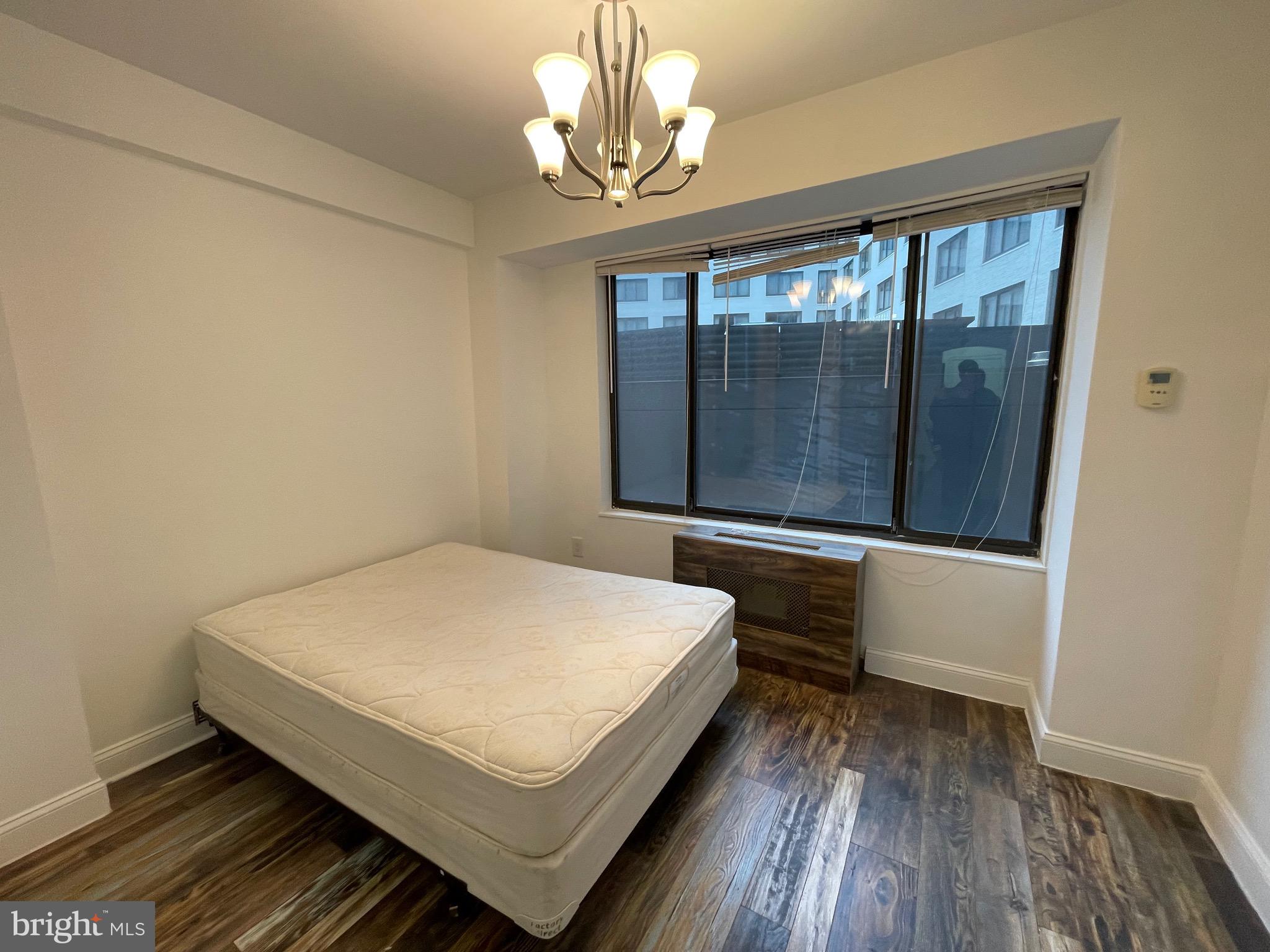 1 Scott Circle Northwest, Unit 118 Washington, DC 20005 - Photo 22 of 35 a bedroom with a bed and window